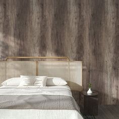 a bed with white sheets and pillows in front of a wooden wallpapered bedroom