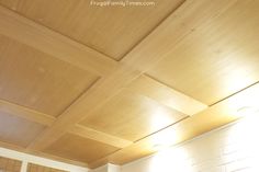 an empty room with wood paneling on the ceiling