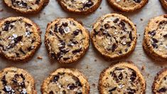 chocolate chip cookies are arranged on a baking sheet