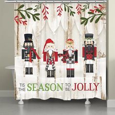 a christmas themed shower curtain with three nutcrackers and holly branches on it