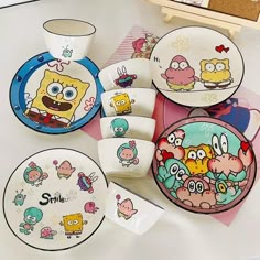 various cartoon plates and cups on a table