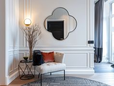 a living room with a chair and mirror on the wall