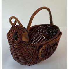 a brown wicker basket sitting on top of a white table