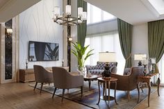 a living room filled with furniture and a large window covered in green draping