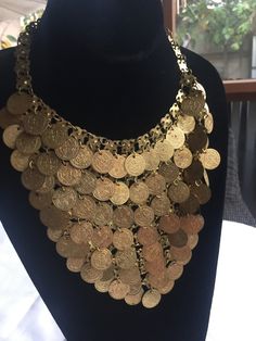 Exotic Coin Bib Necklace made up of dozens of dangly coins hanging in a triangle. Lightweight enough to be comfortable and it also moves beautifully when you move, catching the light. Its bib area is about 7.5" across and 7" deep and the chain is about 16" around. I was told when I bought this at an estate sale that it was actually a Bunny costume worn at the Playboy Mansion, but I can't find any authentication of that story! Please take a look at my storefront at: https://www.etsy.com/shop/FabFinds42?ref=seller-platform-mcnav I have a wide selection of one-of-a-kind items, from clothing and toys to home decor and gift items, and I add new things almost every day. Solarpunk Fashion, Cleopatra Necklace, Egyptian Accessories, Coin Necklace Gold, Playboy Mansion, Egypt Jewelry, Egyptian Necklace, Dance Stuff, Orange Bracelet