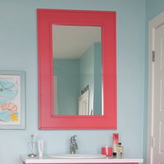 a bathroom with blue walls and pink vanity