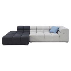 a large sectional couch with blue pillows on it's back and the seat folded out