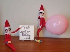 two elfs are sitting next to a sign that says don't suellow bubble gum