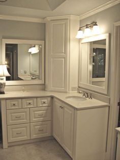 a white bathroom with two sinks and mirrors