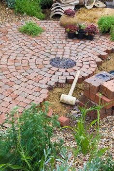 a brick patio with an umbrella in the middle