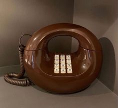 an old fashioned telephone is sitting on the floor in a room with no one around it