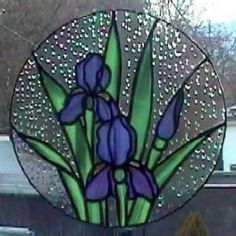 a stained glass window with purple flowers on it