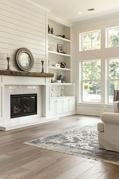 a living room with white walls and wood floors