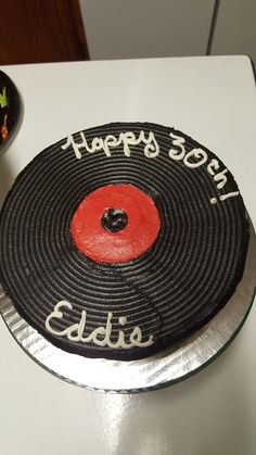 a black and red birthday cake on a table