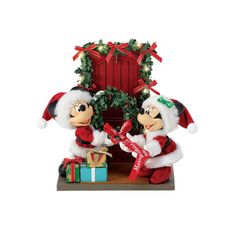 two mickey and minnie mouse christmas figurines with presents