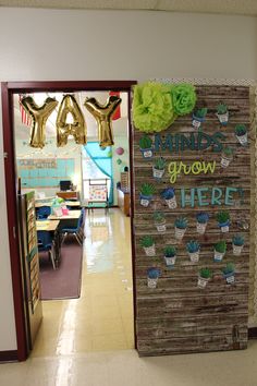 a classroom door decorated with flowers and plants that say, minds grow here on it