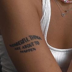 a woman's arm with the words wonderful things are about to happen written on it