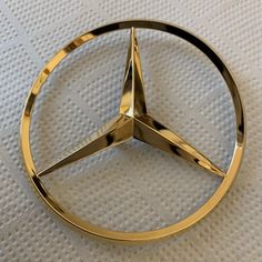 a mercedes emblem is shown on a white surface