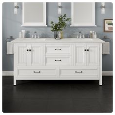 a white bathroom vanity with two mirrors above it and a vase on the counter top