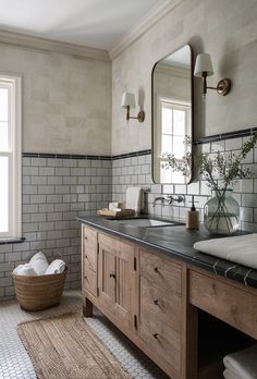 a bathroom with two sinks and a large mirror