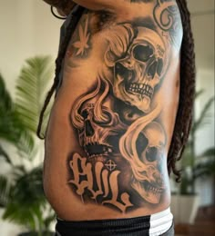 a man with tattoos and dreadlocks on his stomach is holding up his arm