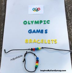 the olympic game is bracelets made from beads and plastic letters on a piece of paper