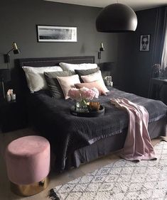 a bedroom with black walls and pink accents