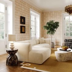 a living room filled with furniture and a potted plant