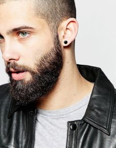 a man with a beard wearing a leather jacket