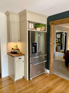 a kitchen with an oven, refrigerator and dining room table in the backround