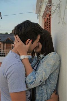 a young man and woman kissing each other