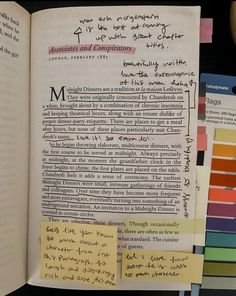 an open book with writing on it and sticky notes attached to the pages next to each other