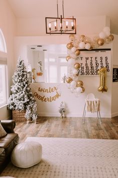 a living room decorated for christmas with gold and white balloons hanging from the ceiling above