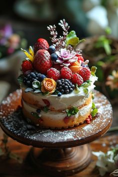 there is a cake with berries and flowers on it