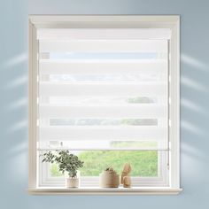 a window with white blinds and potted plants