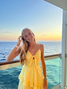 a woman in a yellow dress on a cruise ship