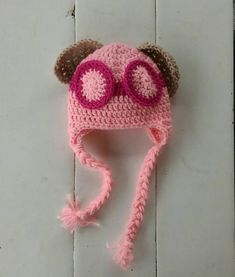 a crocheted hat with eye glasses on it