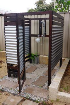 an outdoor shower in the middle of a yard