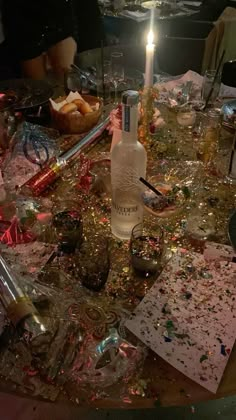 the table is covered with confetti, candles and other items that have been left on it