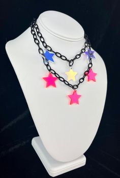 FREE Shipping on orders $35 and up! Star Girl Choker The Star Girl choker is made with high-quality lightweight material, perfect for raves and festivals! The iridescent star charms shine and reflect prisms of light under the sun. - Charms are made with lightweight iridescent acrylic- color appearance changes depending on lighting - Adjustable from 14 to 16 inches (message me for length customizations up to 20-22inches) Matching earrings here!- https://www.etsy.com/listing/1380601428/star-irides Adjustable Rave Choker For Festival, Adjustable Multicolor Rave Choker, Trendy Rainbow Necklace For Festivals, Adjustable Rave Style Choker, Trendy Multicolor Star Necklace, Trendy Multicolor Star Shaped Necklace, Rainbow Adjustable Choker For Festival, Rainbow Adjustable Choker For Festivals, Multicolor Rave Jewelry For Festival