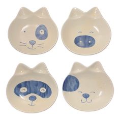 four blue and white plates with cats on them