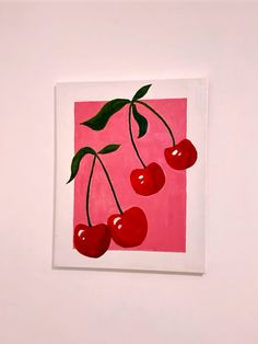 a painting of three cherries on a pink background