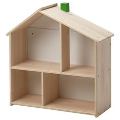 a wooden doll house with three shelves and a green stick sticking out of the roof