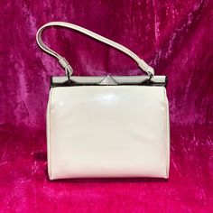 D E S C R I P T I O N This Is A 1950's Cream Colored Patent Leather A Frame Bag With Gold Tone Hardware. Ridged Golden Triangle Push Clasp. This Is In Good Vintage Condition Some Signs Of Wear Are Evident: Minor Scratches On The Patent Leather, And Some Separation To Bottom Corners Inner Crease. M E A S U R E M E N T S Bag Width: 4.5” Bag Height: 8” Bag Length: 9” Authenticity Guarantee All Bags Sold In Our Shop Are 100% Guaranteed Authentic Or Your Money Back. Vintage Square Evening Bag, Vintage White Rectangular Bag, Retro Cream Bag For Daily Use, White Vintage Rectangular Bag, Vintage Square Evening Bag For Formal Occasions, White Rectangular Vintage Bag, Classic Cream Rectangular Satchel, Retro Rectangular Evening Bag For Vintage Fashion, Classic Beige Evening Bag