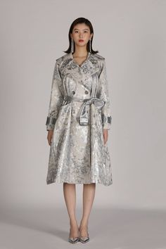 Silver Flora trench coat is uniquely crafted with adjustable straps on waist and cuffs, which ensures the tailored fit and perfect level of snugness and comfort. This coat excels in durability and wind resistance. Material: Cotton, Nylon Silver Trench Coat, Winter Long Fitted Raincoat, Elegant Long Winter Raincoat, Elegant Winter Raincoat With Long Sleeves, Elegant Long Raincoat For Fall, Elegant Long Sleeve Winter Raincoat, Elegant Long Fall Raincoat, Belted Long Raincoat For Spring, Elegant Fall Raincoat