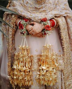 a close up of a person wearing gold jewelry