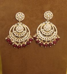 Metal = Gold Plated Occasion = Wedding ,Party Wear, Bridal Color = White and Red Size = Earrings Size - 3.5 Inches(approx) Closure = Screw Back 100% Satisfaction Guarantee: 1 Year Warranty, Long Lasting Plating, High-Quality Stones Occasion: Perfect choice for any Indian occasion. Care: It is advisable that you keep products away from direct heat, humidity, and moisture. It is best to preserve your jewelry in the box. Keep Away From Water, Spray And Perfumes For Better Look. Free Shipping Worldw Kundan Bridal Earrings For Marriage, Meenakari Earrings For Marriage And Festivals, Festive Bridal Earrings With Stone Work For Marriage, Festive Meenakari Bridal Earrings For Marriage, Meenakari Chandbali Bridal Earrings, Festive Bridal Meenakari Earrings For Marriage, Festive Bridal Meenakari Earrings, Traditional Heavy Earrings For Marriage, Festive Chandbali Jhumkas For Wedding