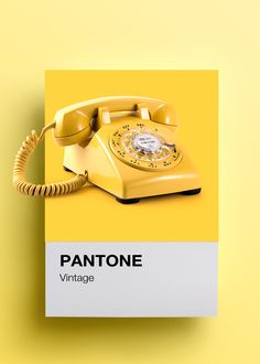 an old yellow phone sitting on top of a card with the word pantone written below it