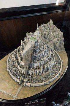 a model of a castle on top of a wooden table next to a pen and marker