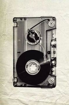 a black and white photo of a hard drive with a disk attached to the side